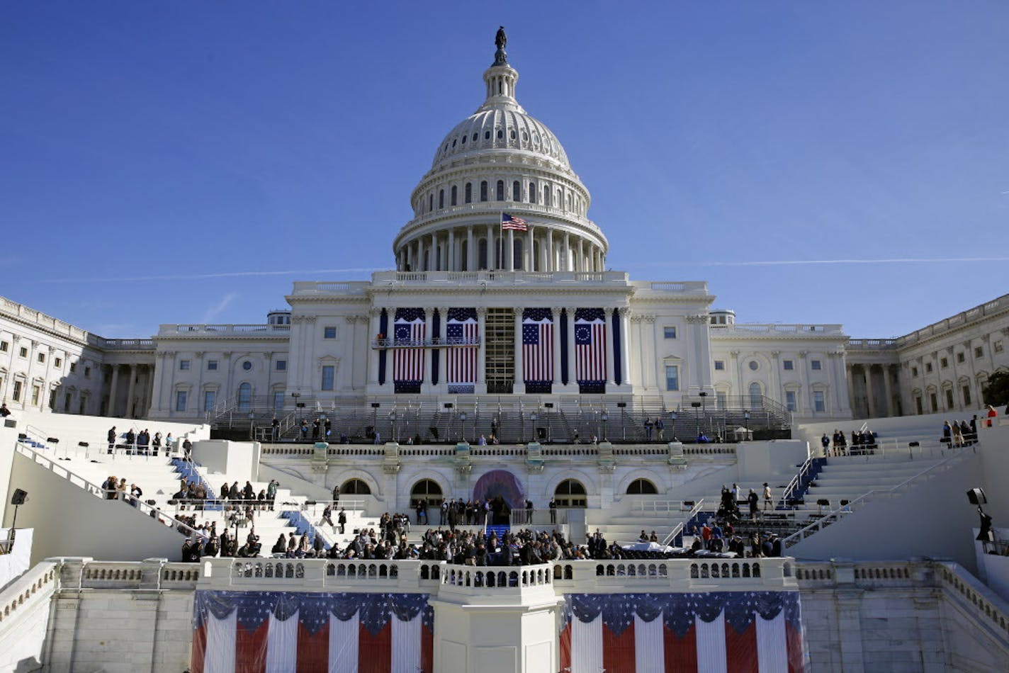 In this Jan. 15, 2016, photo, the U.S. Capitol frames the backdrop over the stage during a rehearsal of President-elect Donald Trump's swearing-in ceremony in Washington. Some two dozen House Democrats plan to boycott Trump&#xed;s inauguration on Friday, casting the Republican businessman as a threat to democracy. (AP Photo/Patrick Semansky) ORG XMIT: MIN2017011709131103