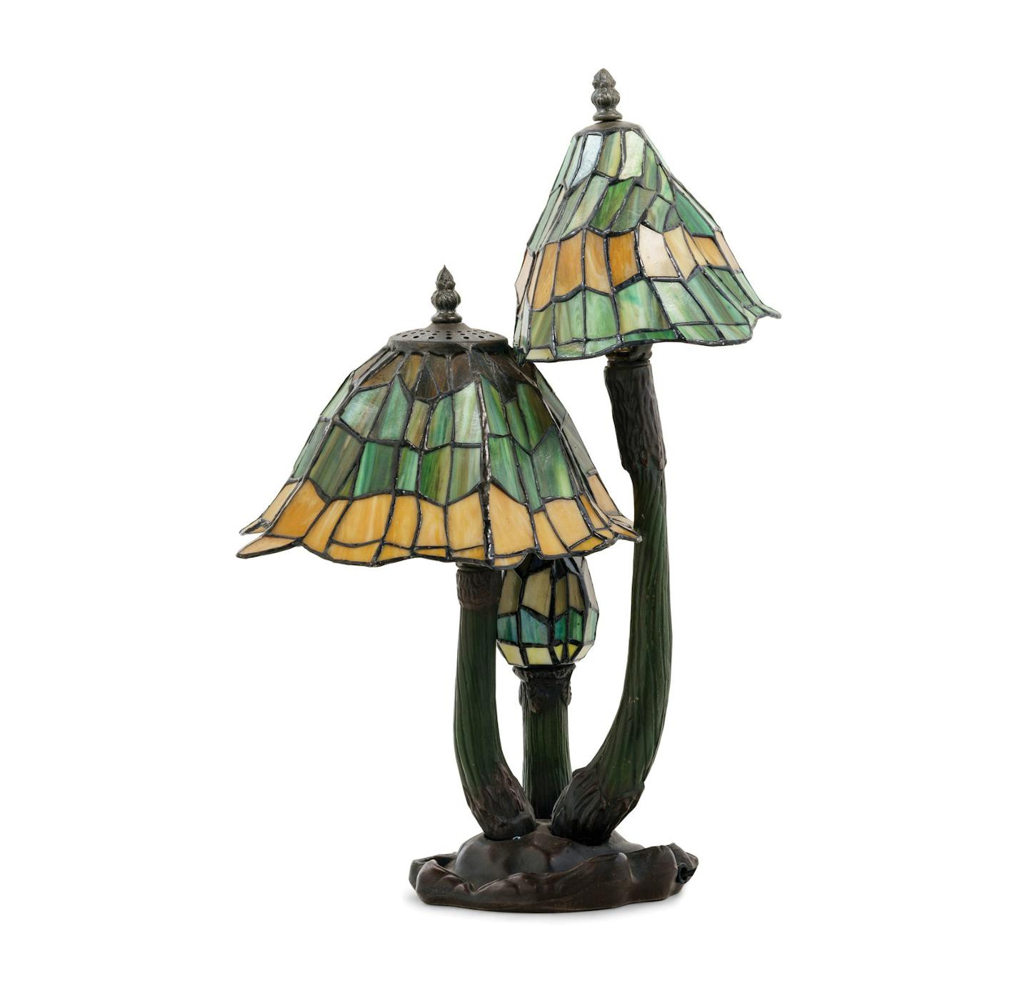 This lamp's maker has not been identified, but it resembles the famous Tiffany lamps of the early 20th century. Its mushroom motif and narrow, asymmetrical curves recall the stylized nature shapes of art nouveau.