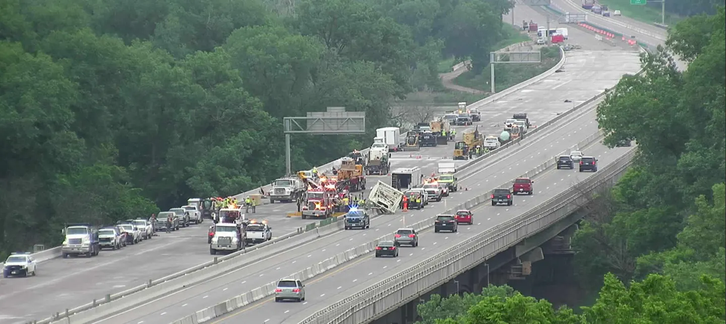 Major traffic backup on highway as semi truck spills load