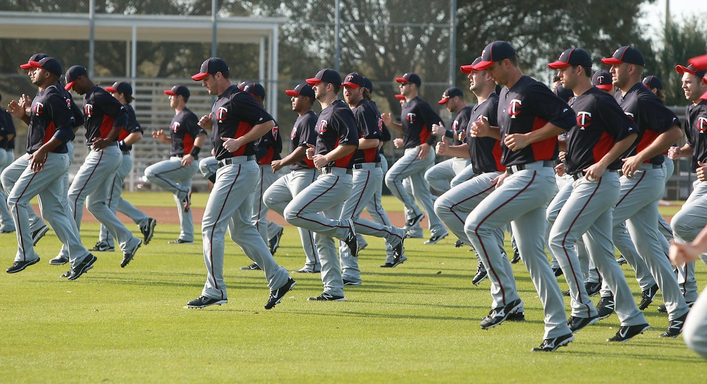 Twins catchers and pitchers warmed up before practice at Hammond Stadium on Tuesday.