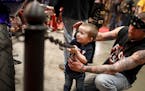 Tucker LuAllen, 2, hangs with his dad Tony LuAllen of Elk River at the Donnie Smith Bike Show, an annual celebration of biker culture that draws hundr