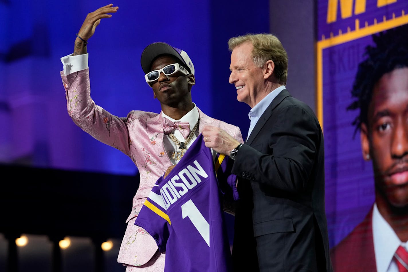 USC wide receiver Jordan Addison, left, and Roger Goodell, NFL Commissioner, hold a team jersey after Addison was chosen by the Minnesota Vikings with the No. 23 pick at the 2023 NFL Draft, Thursday, April 27, 2023, in Kansas City, Mo. (AP Photo/Steve Luciano)