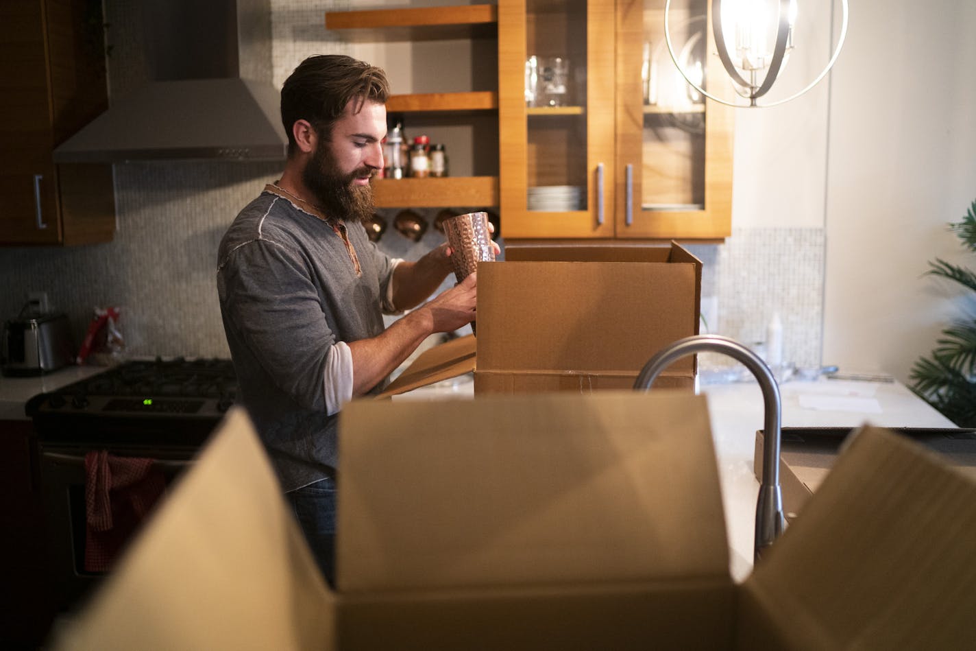 Erik McLaughlin packed up his kitchen as he prepared for his move from an Uptown apartment to the North Loop in Minneapolis, Minn, on Thursday, September 10, 2020.