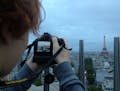 The author's son, Jackson Hughlett, shoots a bird's eye view of the Eiffel Tower in Paris. ] Photo by Katy Read/Star Tribune
