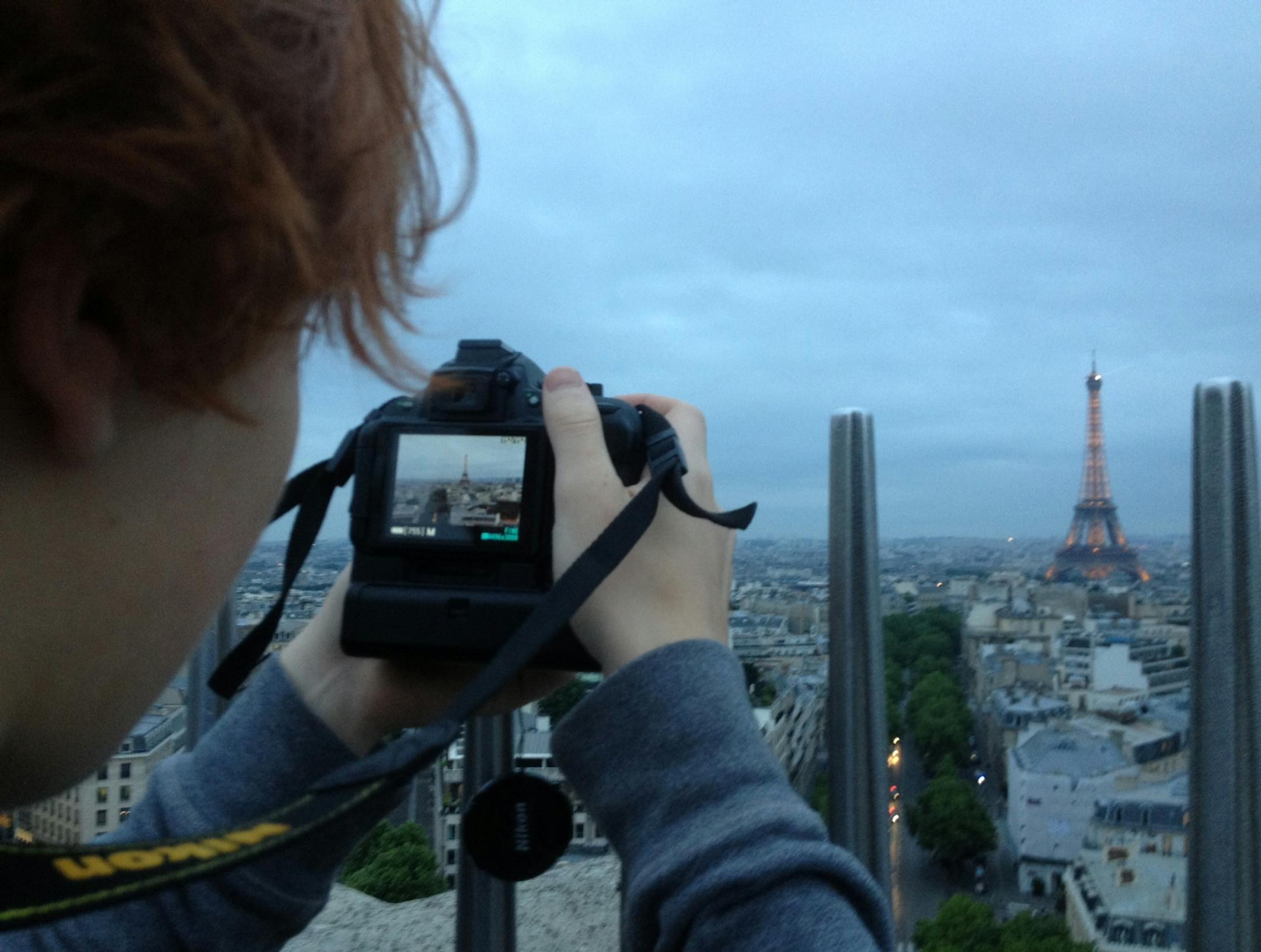 The author's son, Jackson Hughlett, shoots a bird's eye view of the Eiffel Tower in Paris. ] Photo by Katy Read/Star Tribune