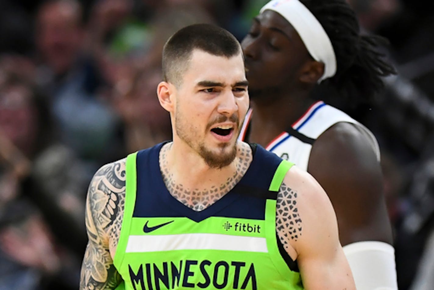 Boston Celtics center Enes Kanter (11) drives on plays against the Minnesota Timberwolves forward Juancho Hernangomez during an NBA basketball game Friday, Feb. 21, 2020, in Minneapolis. (AP Photo/Andy Clayton-King)