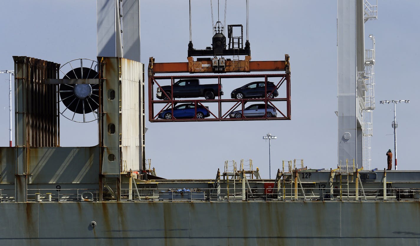 In this July 13, 2017, file photo, a crane transporting vehicles operates on a container ship at the Port of Oakland, in Oakland, Calif.