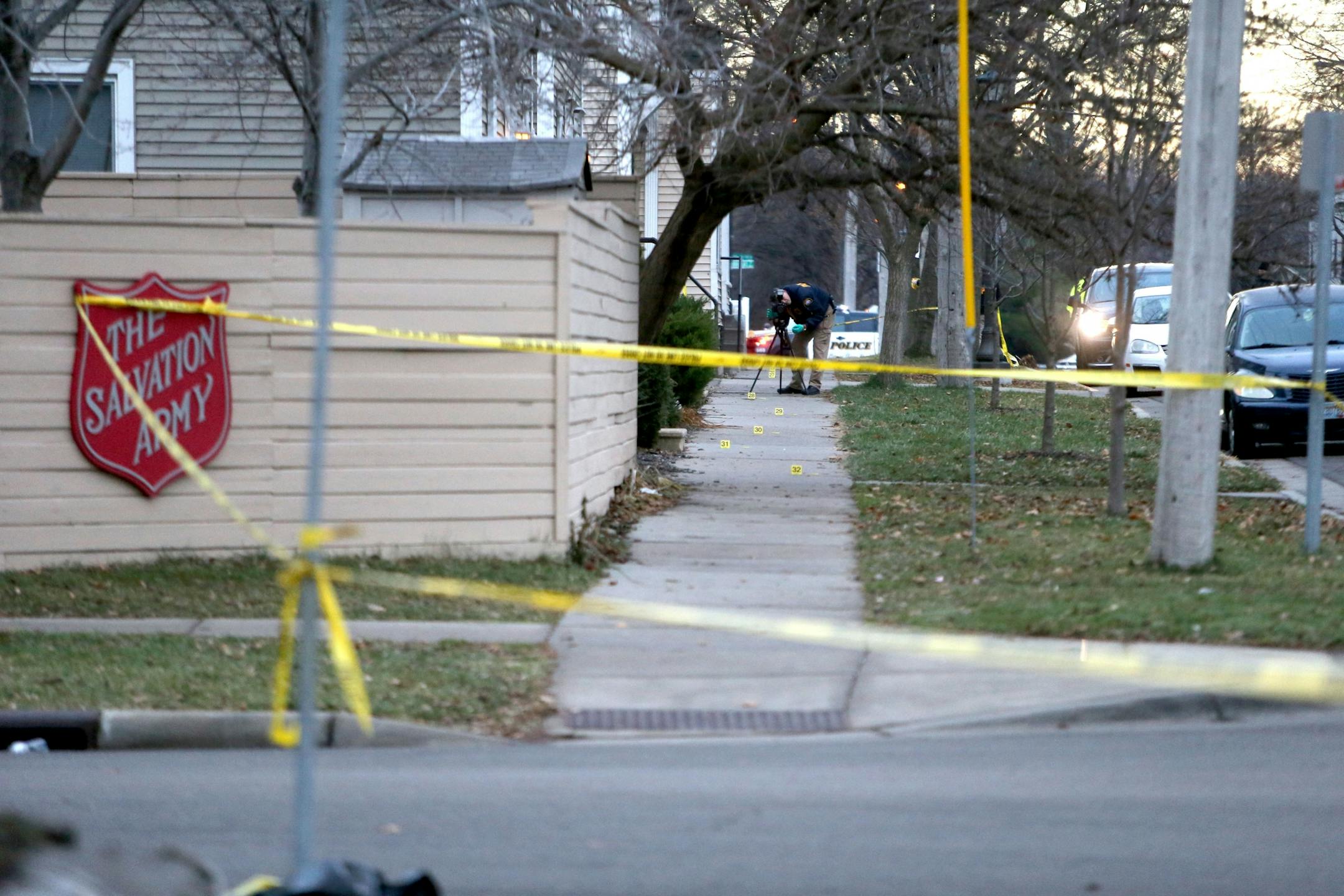 Scene of an early morning homicide where two persons are dead and a third critically wounded near the Salvation Army at 7th St and Smith Ave. Thursday, Dec. 10, 2015, in St. Paul, MN. Here, a police officer shoots video of the scene outside the closed down Salvation army near Douglas and 7th St.