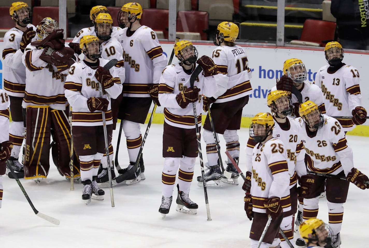 The Minnesota team stands on the ice after a 4-3 loss to Penn State in two overtimes in a semifinal of the Big Ten college hockey tournament, Friday, March 17, 2017, in Detroit. (AP Photo/Carlos Osorio)