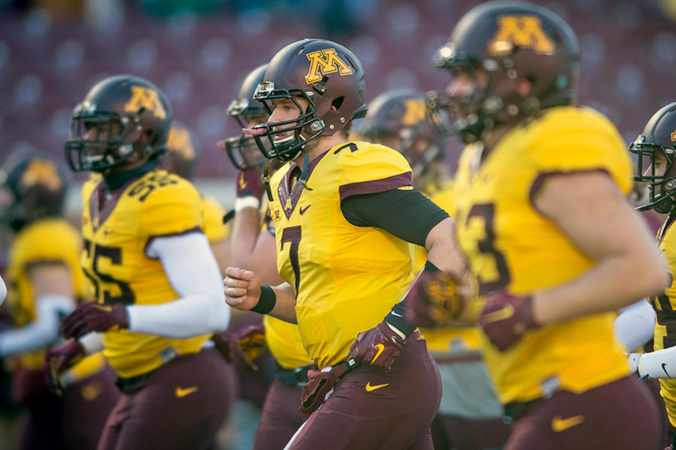 Gophers players, including quarterback Mitch Leidner (7), ran into a pre-game huddle before heading to the locker room before the Illinois game.