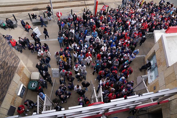 Fans waited in line to get in the entry gates at Target Field in March 2019.