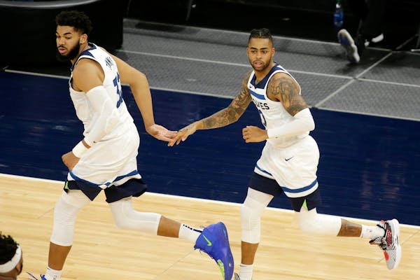 Minnesota Timberwolves center Karl-Anthony Towns (32) and guard D'Angelo Russell (0) celebrate a basket against the Chicago Bulls in the second quarte