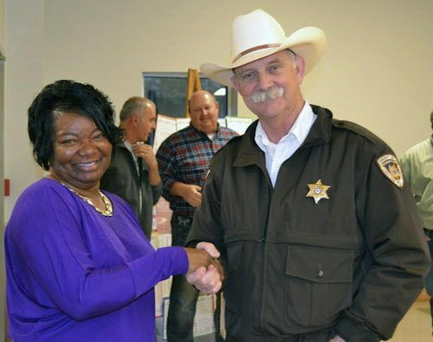 In this March 6, 2016 photo, Choctaw County Sheriff Cloyd Halford shakes the hand of Juliette Ashford during the annual First Responders Dinner at the Choctaw County Community Center in Ackerman, Miss. Halford says it's not his fault that Jessica Jauch was held for 96 days without a hearing before a judge, a lawyer or bail. Halford and the county told a federal judge that scheduling such hearings were the responsibility of a state court judge or district attorney.