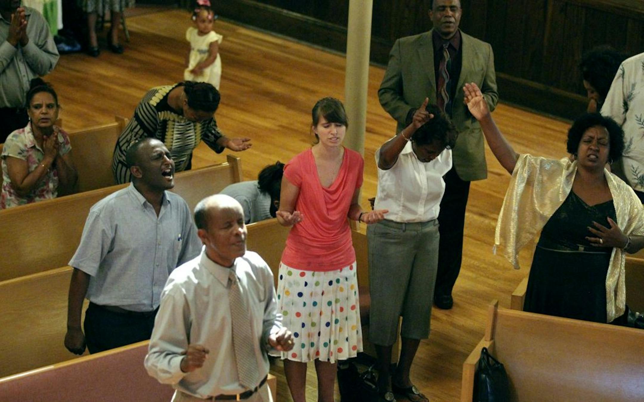 Sarah Koscielniak(center) worshipped with members of an Ethiopian congregation, which meets at Central Mission church on Sunday July 01, 2012 in St. Paul, MN. .