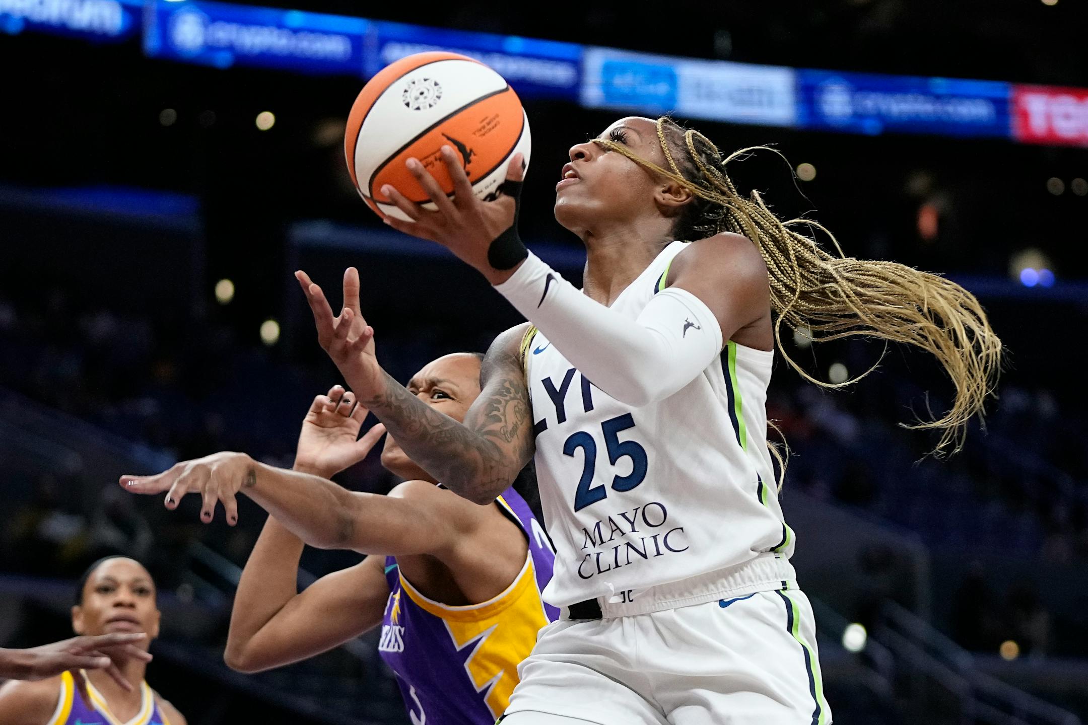 Lynx guard Tiffany Mitchell shot as Los Angeles Sparks forward Azura Stevens defended during the first half Tuesday.