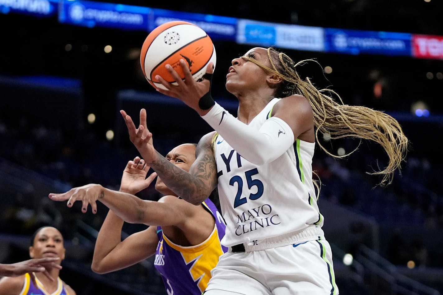 Lynx guard Tiffany Mitchell shot as Los Angeles Sparks forward Azura Stevens defended during the first half Tuesday.