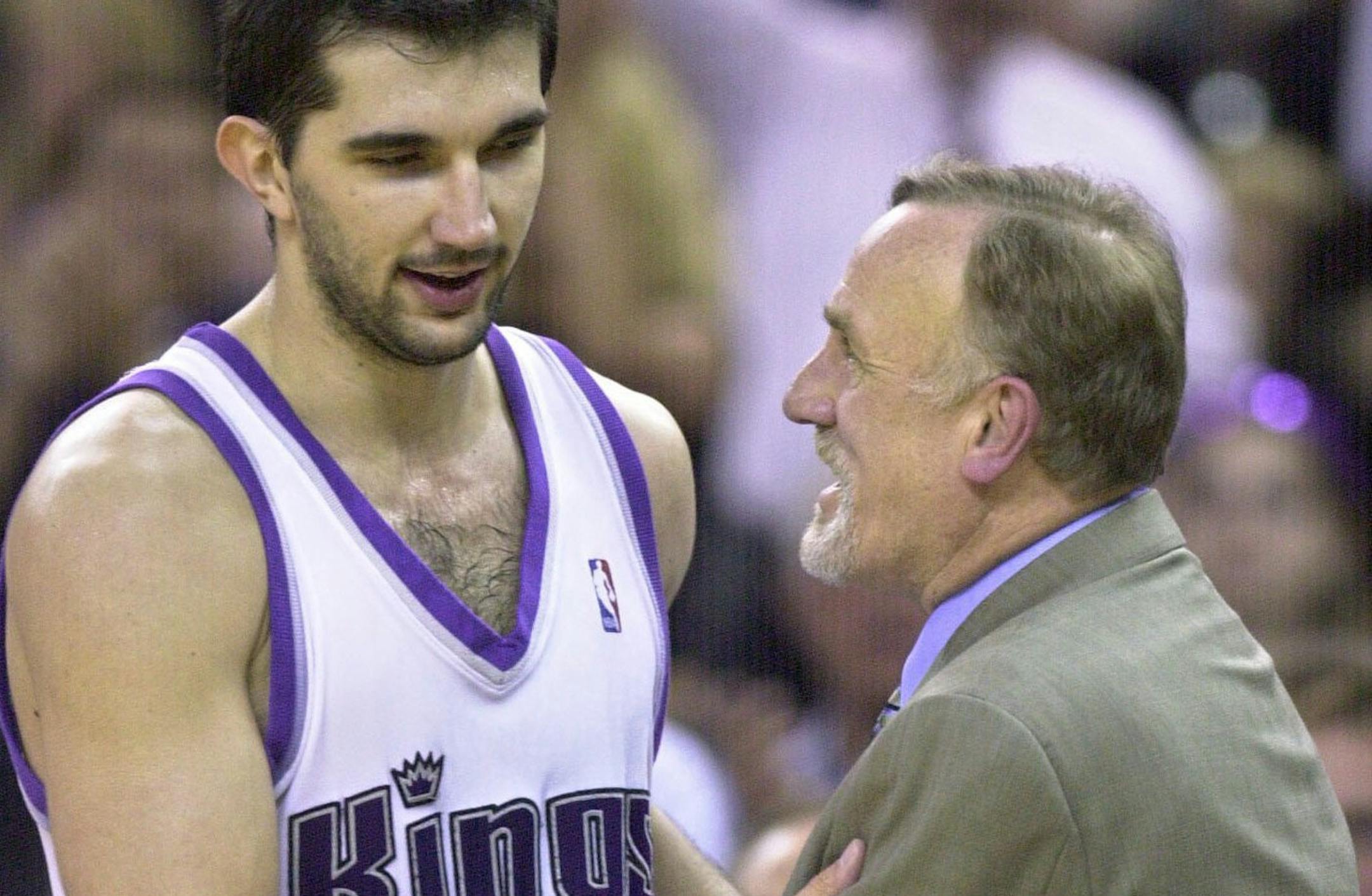 Sacramento Kings coach Rick Adelman, right, congratulates Kings' forward Peja Stojakovic of Yugoslavia as he comes out of the game in the fourth quarter of Game 2 against the Utah Jazz in the first-round of their NBA playoff series at Arco Arena in Sacramento, Calif., Monday, April 21, 2003. Stojakovic scored a game-high 29 points to lead the Kings to a 108-95 win over the Jazz. The Kings now lead the series 2-0. (AP Photo/Rich Pedroncelli) ORG XMIT: SCA117