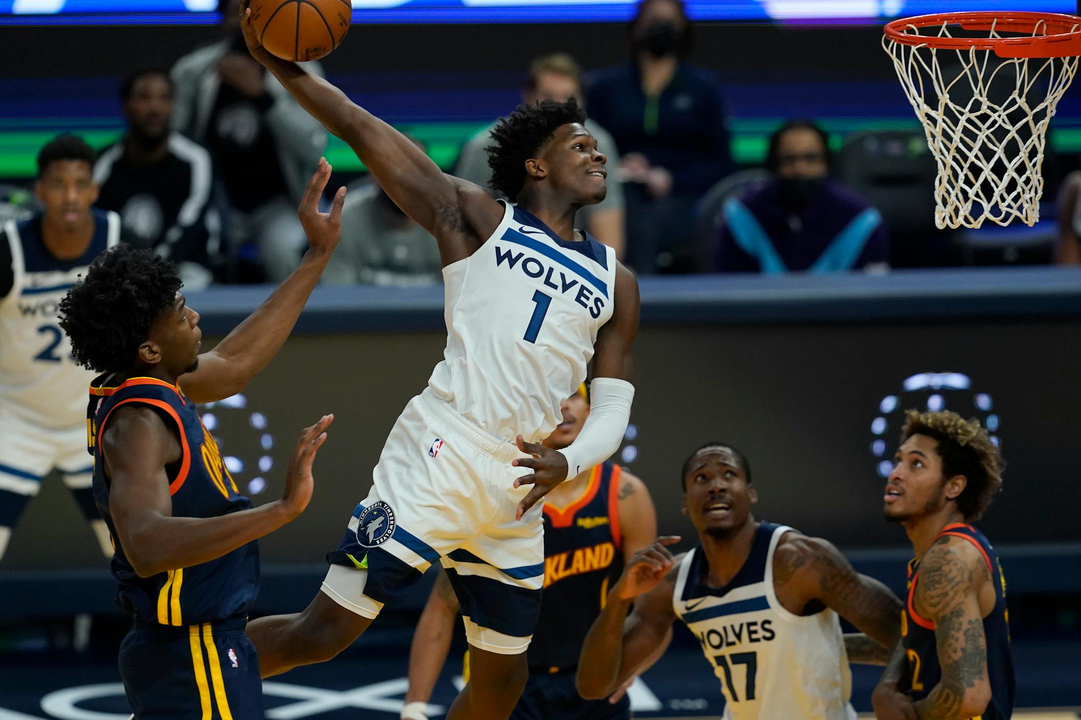 Minnesota Timberwolves guard Anthony Edwards (1) dunks past Golden State Warriors center James Wiseman, left, during the first half of an NBA basketball game in San Francisco, Monday, Jan. 25, 2021. (AP Photo/Jeff Chiu)