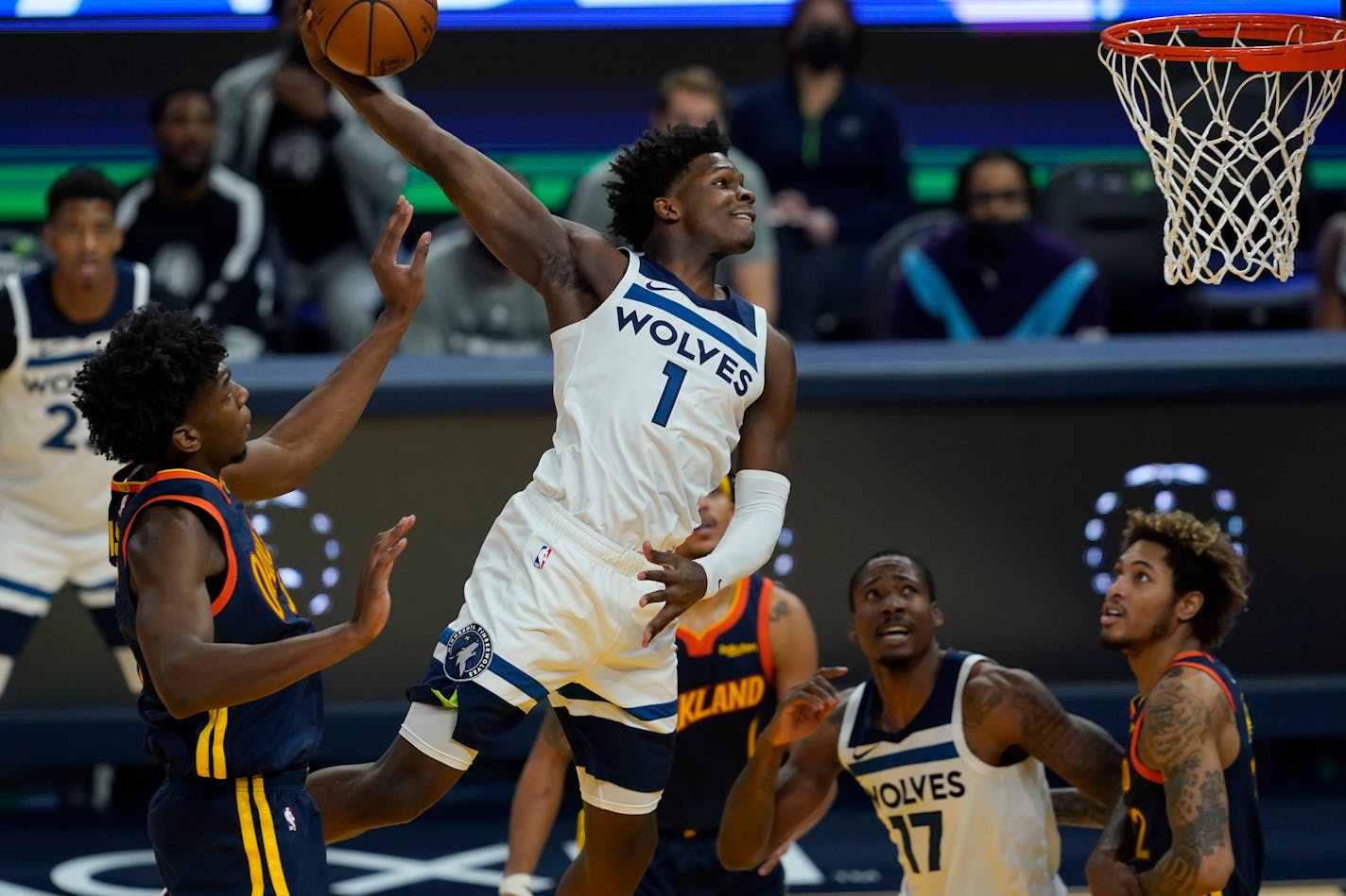 Minnesota Timberwolves guard Anthony Edwards (1) dunks past Golden State Warriors center James Wiseman, left, during the first half of an NBA basketball game in San Francisco, Monday, Jan. 25, 2021. (AP Photo/Jeff Chiu)