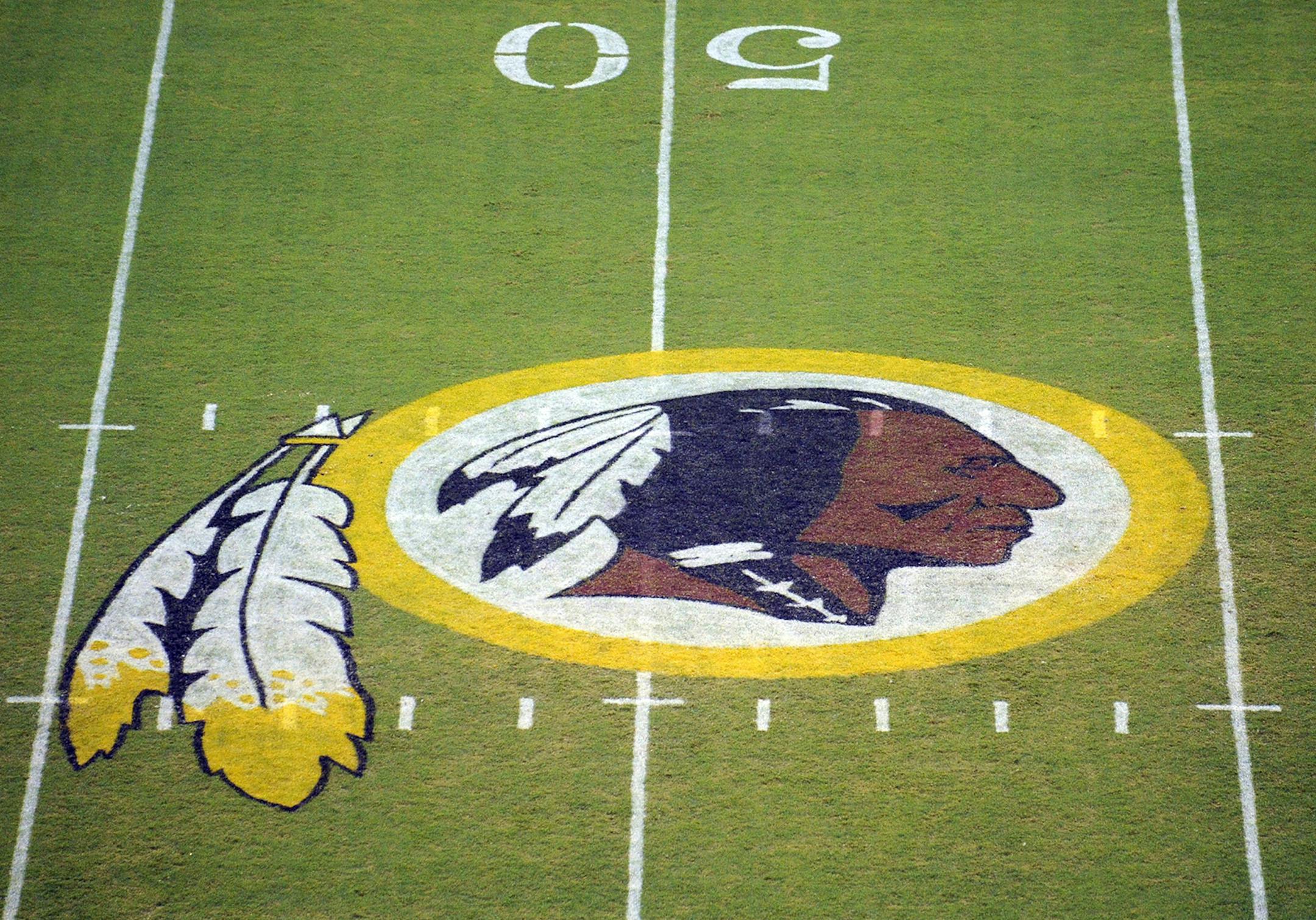 The Washington Redskins logo is shown on the field before the start of a preseason NFL football game against the New England Patriots, Friday, Aug. 28, 2009, in Landover, Md. (AP Photo/Nick Wass) ORG XMIT: NYOTK