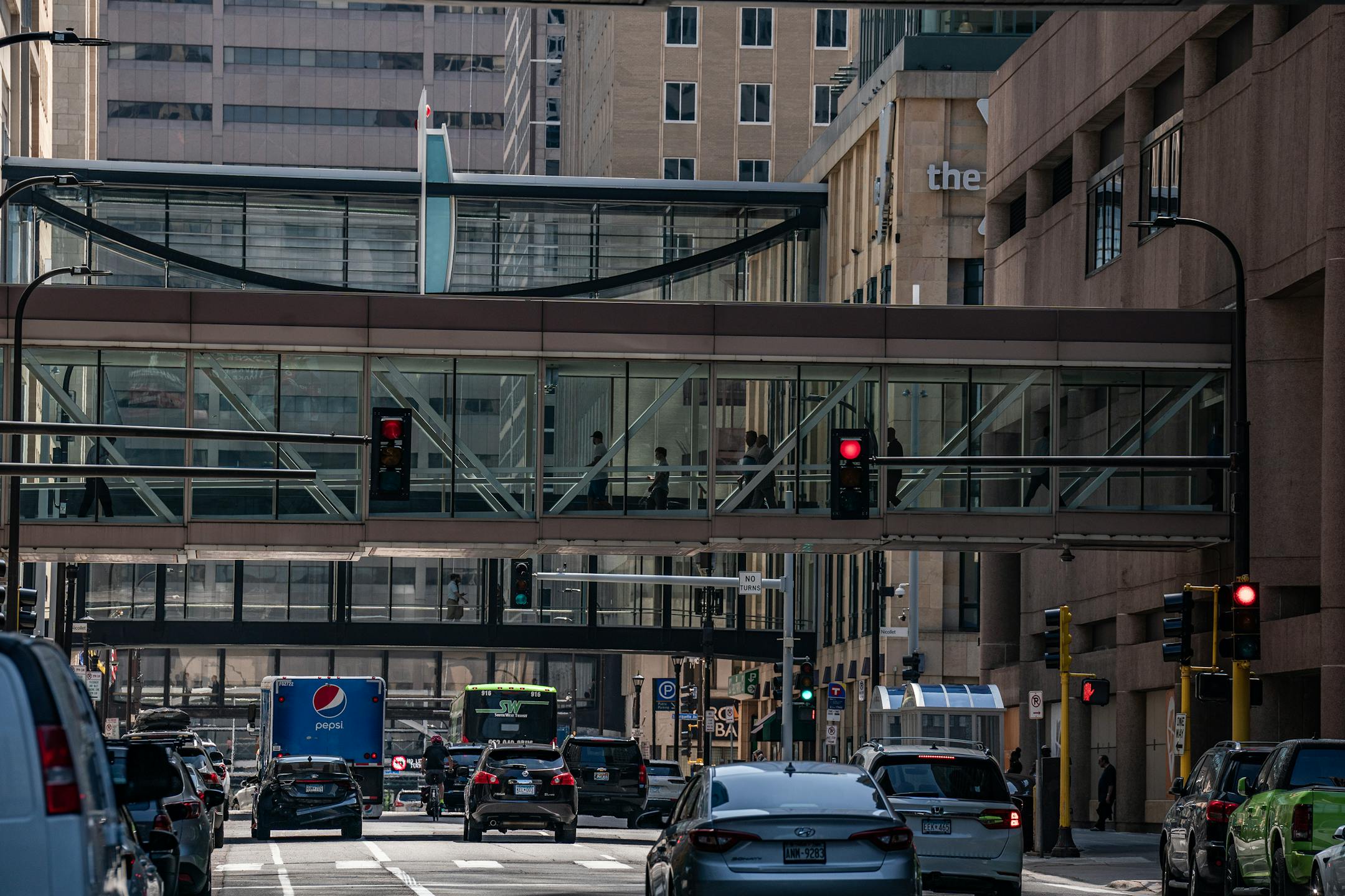 A skyway is visible above a street in downtown Minneapolis on July 31, 2023.