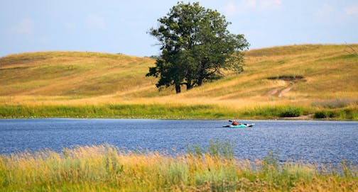 A kayaker paddled on Maple Marsh Lake Wednesday, July 19, 2023 at the Kelly Land and Cattle Co. in Marine on St. Croix, Minn. The 2,600-acre Kelly Farm will be sold to the DNR and Washington County in two phases this summer and fall. The land will become the Keystone Woods Wildlife Management Area. It's the largest ever land purchase for the state's Outdoor Heritage Fund, and the area will become the largest piece of public land in Washington County. ] ANTHONY SOUFFLE • anthony.souffle@startribune.com