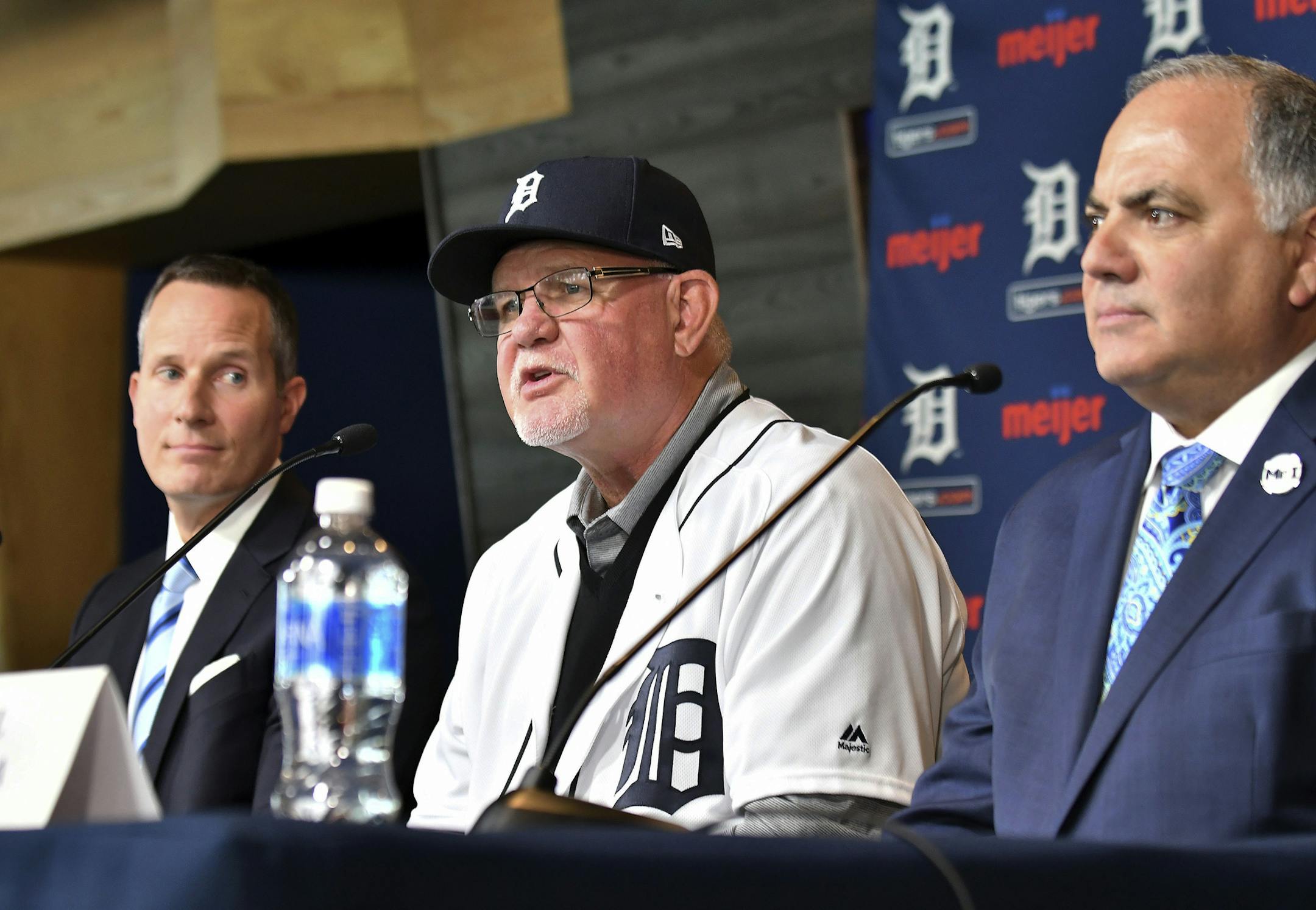 Detroit Tigers baseball team's new manager Ron Gardenhire wears a Tigers hat and jersey as he is flanked by Chris Ilitch, left, president and CEO of Ilitch Holdings, Inc., and Tigers general manager and executive vice president of baseball operations Al Avila, during an introductory press conference at Comerica Park in Detroit, Friday, Oct. 20, 2017. (Robin Buckson/Detroit News via AP)