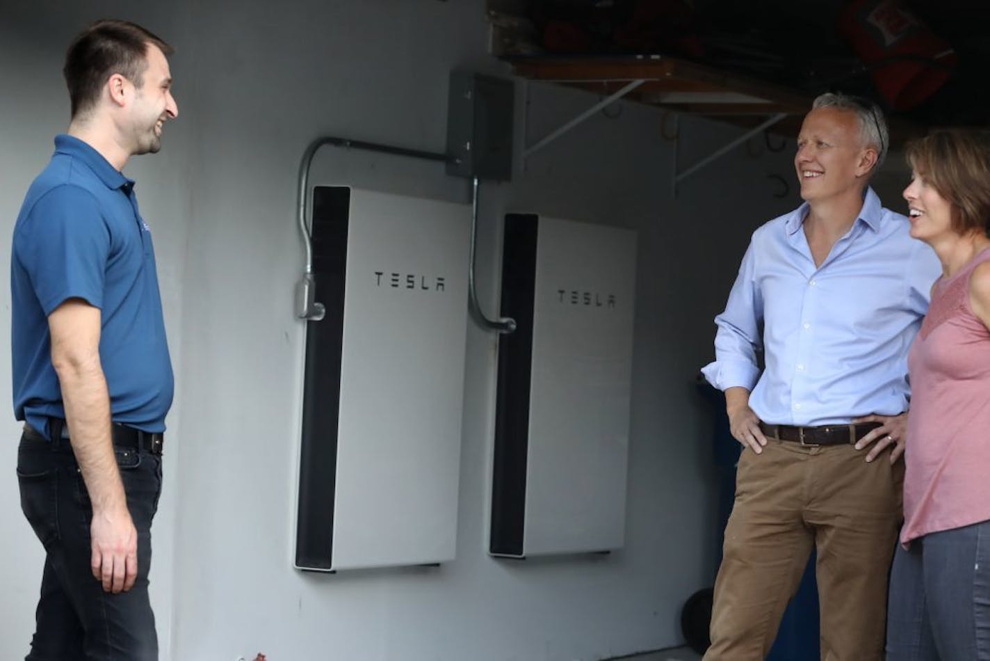 Ryan Buege of St. Paul-based All Energy Solar visited Jordon and Laura Honeck and discussed the Tesla batteries in the background.