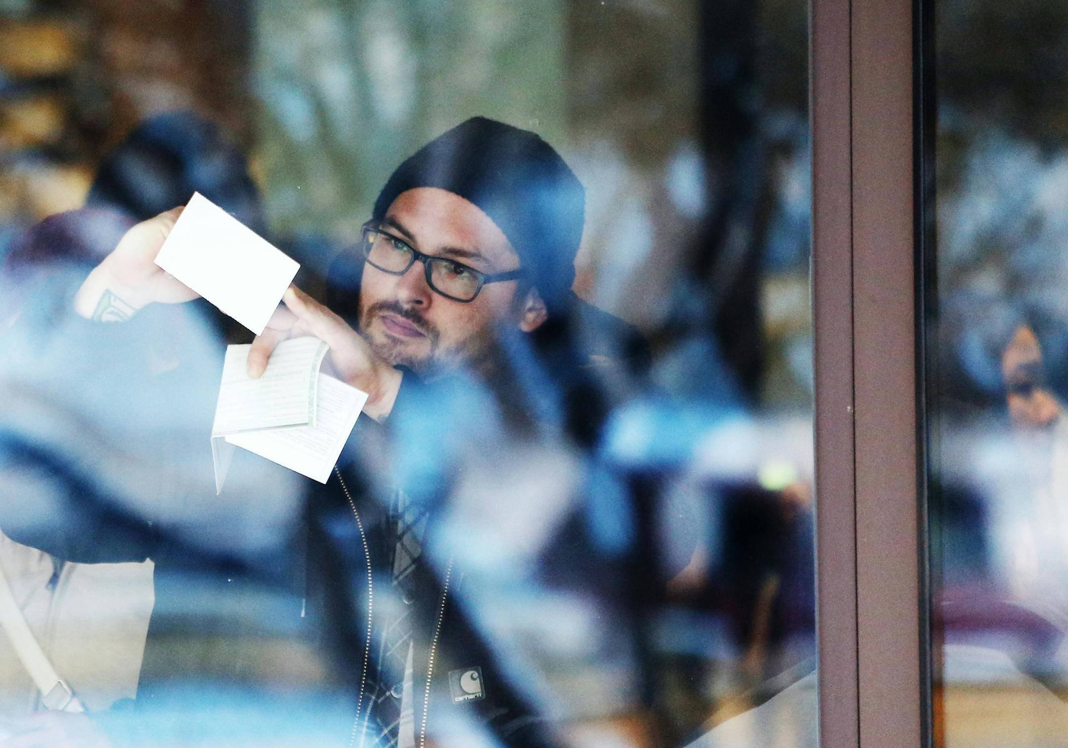 Adam Longfield of Minneapolis used a window to fill out an application to reclaim his towed vehicle at the city of Minneapolis auto impound lot Wednesday, Dec. 30, 2015, in Minneapolis, MN. Longfield's girlfriend had her car towed as well.