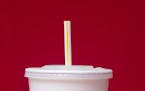 FILE- This May 24, 2018, file photo shows a large soft drink with a plastic straw in Surfside, Fla. The European Union is proposing bans on plastic pr