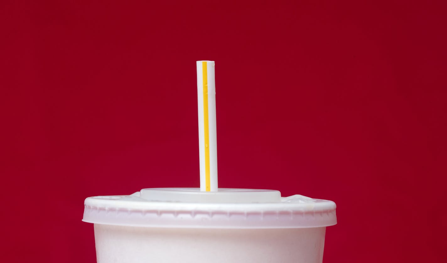 FILE- This May 24, 2018, file photo shows a large soft drink with a plastic straw in Surfside, Fla. The European Union is proposing bans on plastic products like cotton buds, straws, stirs and balloon sticks when alternatives are easily available in an attempt to cut marine litter. (AP Photo/Wilfredo Lee, File)