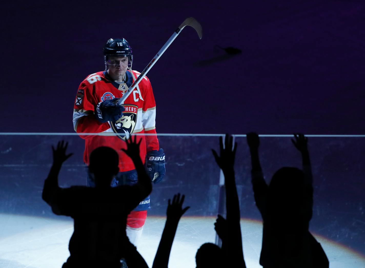 Florida Panthers center Aleksander Barkov gives a fan a hockey stick after being named one of the "Stars of the Game," after the Panthers defeated the Minnesota Wild in an NHL hockey game, March 8, 2019 in Sunrise, Fla. Barkov set a franchise record with five assists. (AP Photo/Wilfredo Lee)