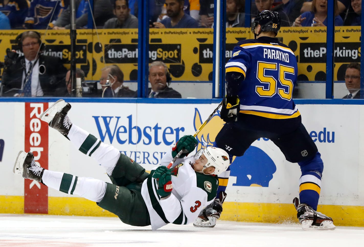 Minnesota Wild's Charlie Coyle (3) falls while chasing after a loose puck with St. Louis Blues' Colton Parayko (55) during the first period in Game 3 of an NHL hockey first-round playoff series Sunday, April 16, 2017, in St. Louis. (AP Photo/Jeff Roberson)