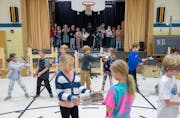 Students rehearse a scene from "Newsies" in the gymnasium Friday, Oct. 27, 2023, at Marine Village School in Marine on St. Croix, Minn. ]