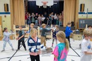 Students rehearse a scene from "Newsies" in the gymnasium Friday, Oct. 27, 2023, at Marine Village School in Marine on St. Croix, Minn. ]
