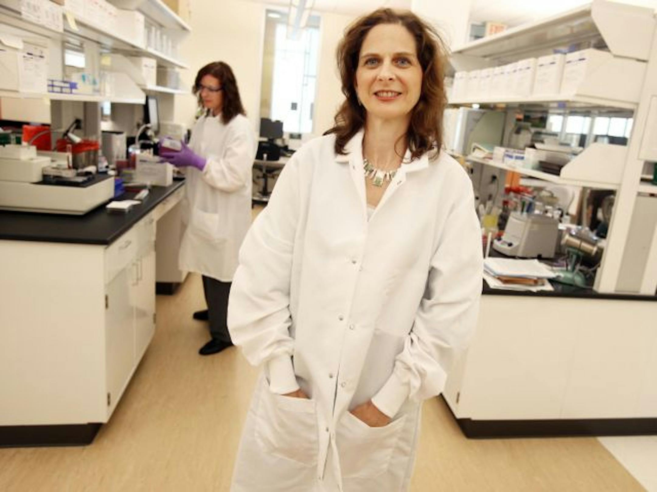Microbiologist Anita Glennen worked with bacteria behind state epidemiologist Dr. Ruth Lynfield at the virology lab in St. Paul.