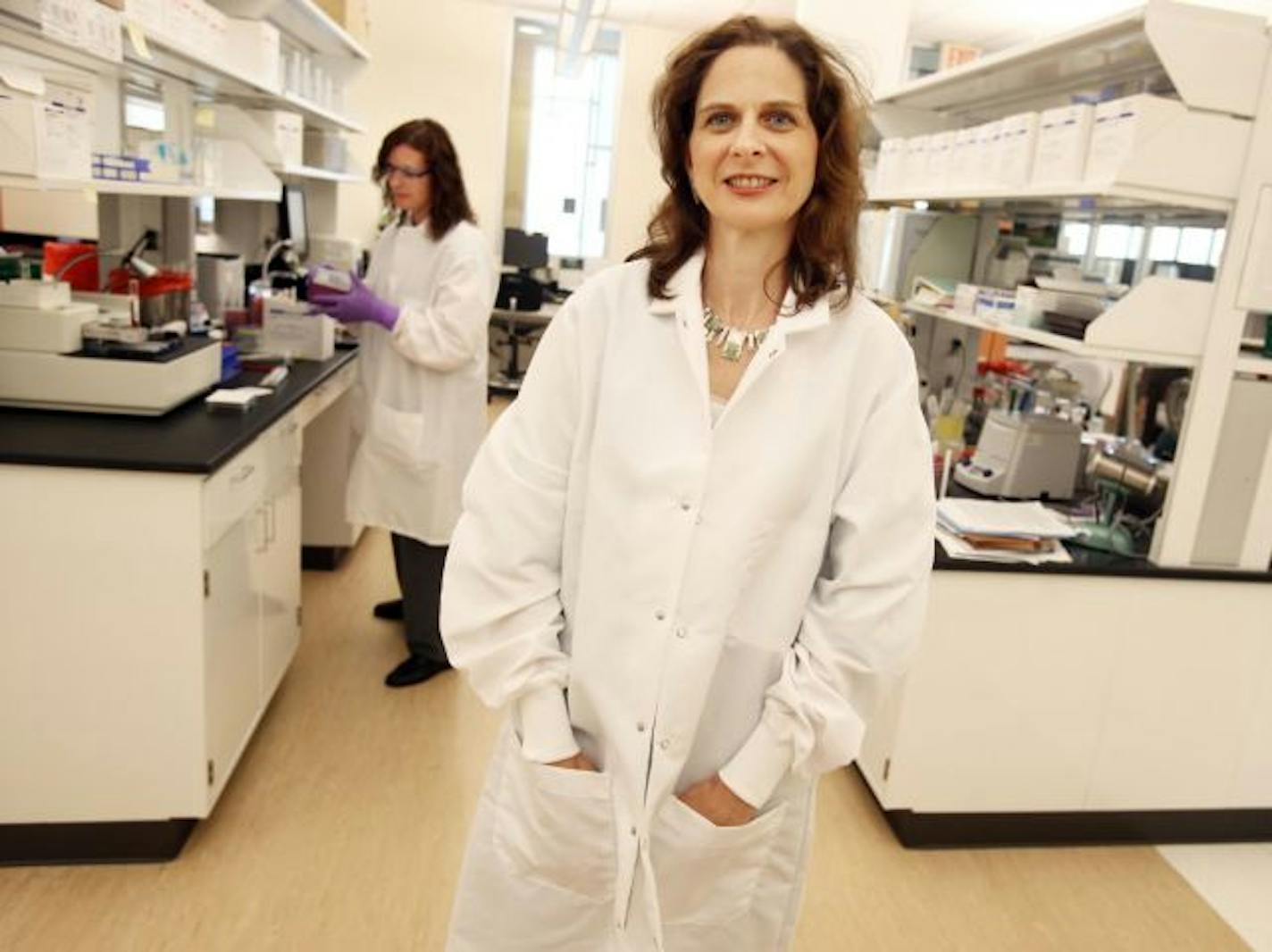 Microbiologist Anita Glennen worked with bacteria behind state epidemiologist Dr. Ruth Lynfield at the virology lab in St. Paul.