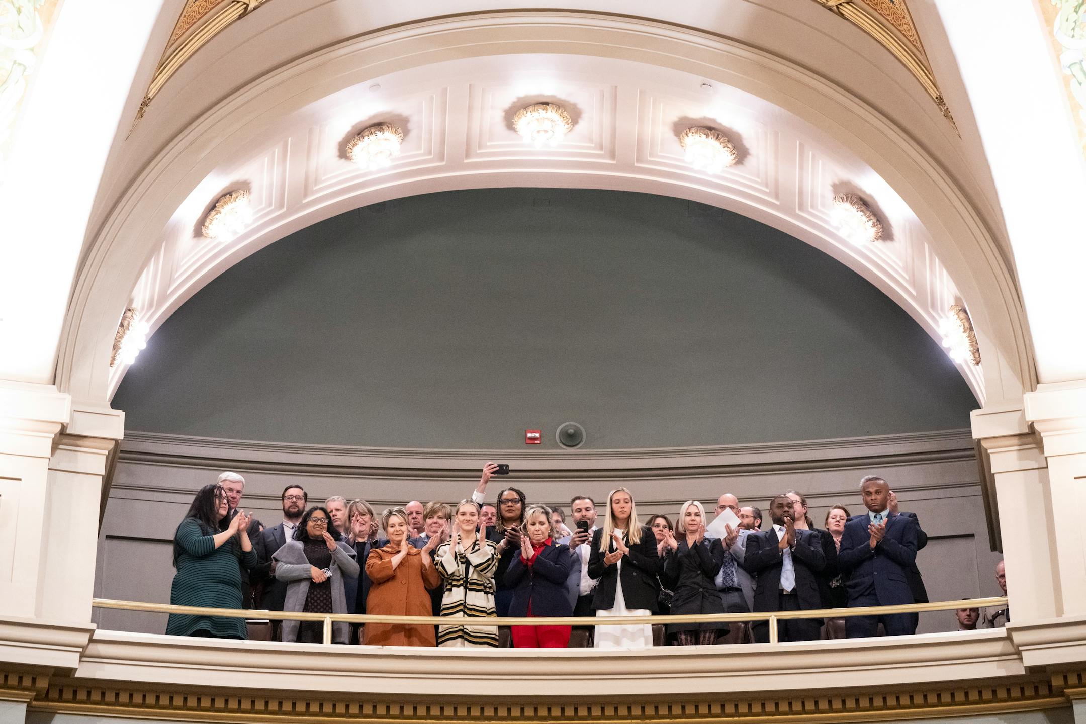 Gallery attendees, including Minnesota first lady Gwen Walz, center, applaud as Gov. Tim Walz is welcomed to the house chambers before the start of the the State of the State address.