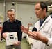 Dr. Joseph Scalea, a transplant surgeon and University of Maryland professor, right, holds a prototype organ monitoring device as he discusses using d