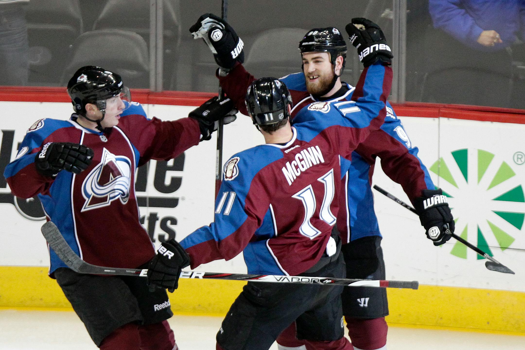 Colorado Avalanche's Ryan O'Reilly, right, is congratulated by teammates Matt Duchene, left, and Jamie McGinn, center, during the first period of an NHL hockey game against the Minnesota Wild on Thursday, Jan. 30, 2014, in Denver. (AP Photo/Barry Gutierrez)