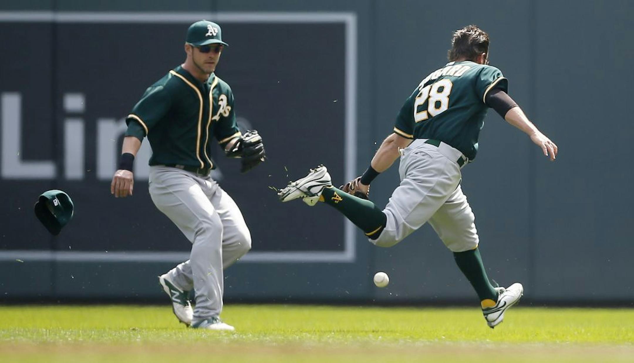 A single by Trevor Plouffe in the second inning fell between A's Eric Sogard and right fielder Josh Reddick during MLB action between the Minnesota Twins and Oakland A's at Target Field April 9, 2014 in Minneapolis , MN.