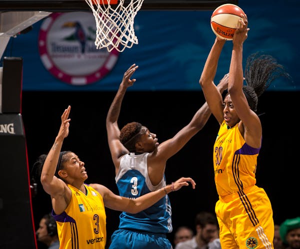 Sparks forward Nneka Ogwumike pulled down a rebound while being challenged under Minnesota's basket by Lynx forward Natasha Howard (3) in a June meeti
