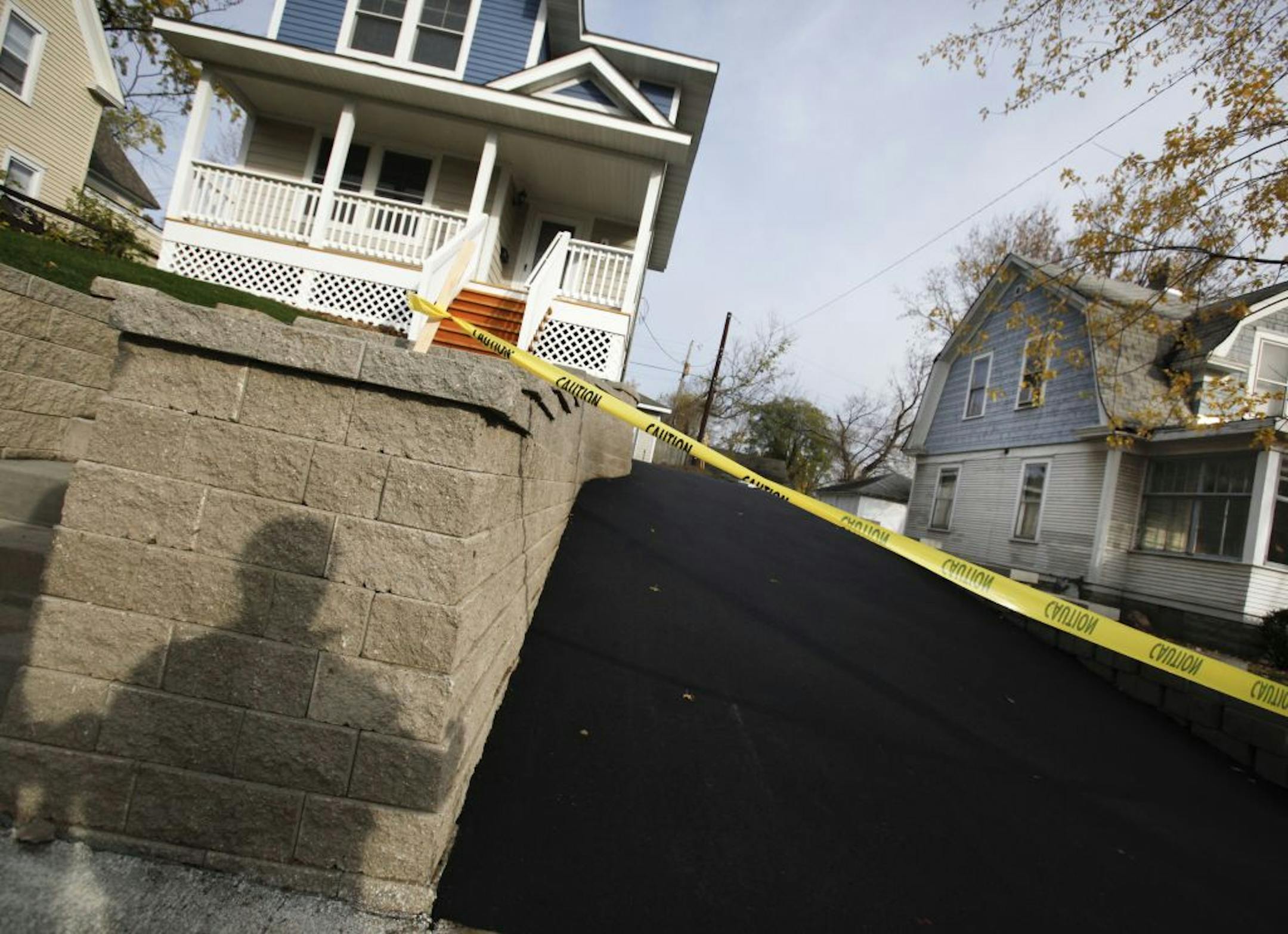 Jeff Skrenes, the Hawthorne neighborhood housing director, cast a shadow as he talked about how new construction homes like the one at left near 30th Ave. N. and 6th St. N. in the Hawthorne EcoVillage are being built to fit in with the existing homes in the neighborhood but that the new homes may not have been factored into a a new study recently released that ranked Hawthorne as one of the worst neighborhoods in Minneapolis for housing conditions. Skrenes did a walking tour of some of Hawthorne