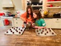 Kristiana, 11, and MaryKate, 10, from Arden Hills, scoop the batter for chocolate brownie cookies.