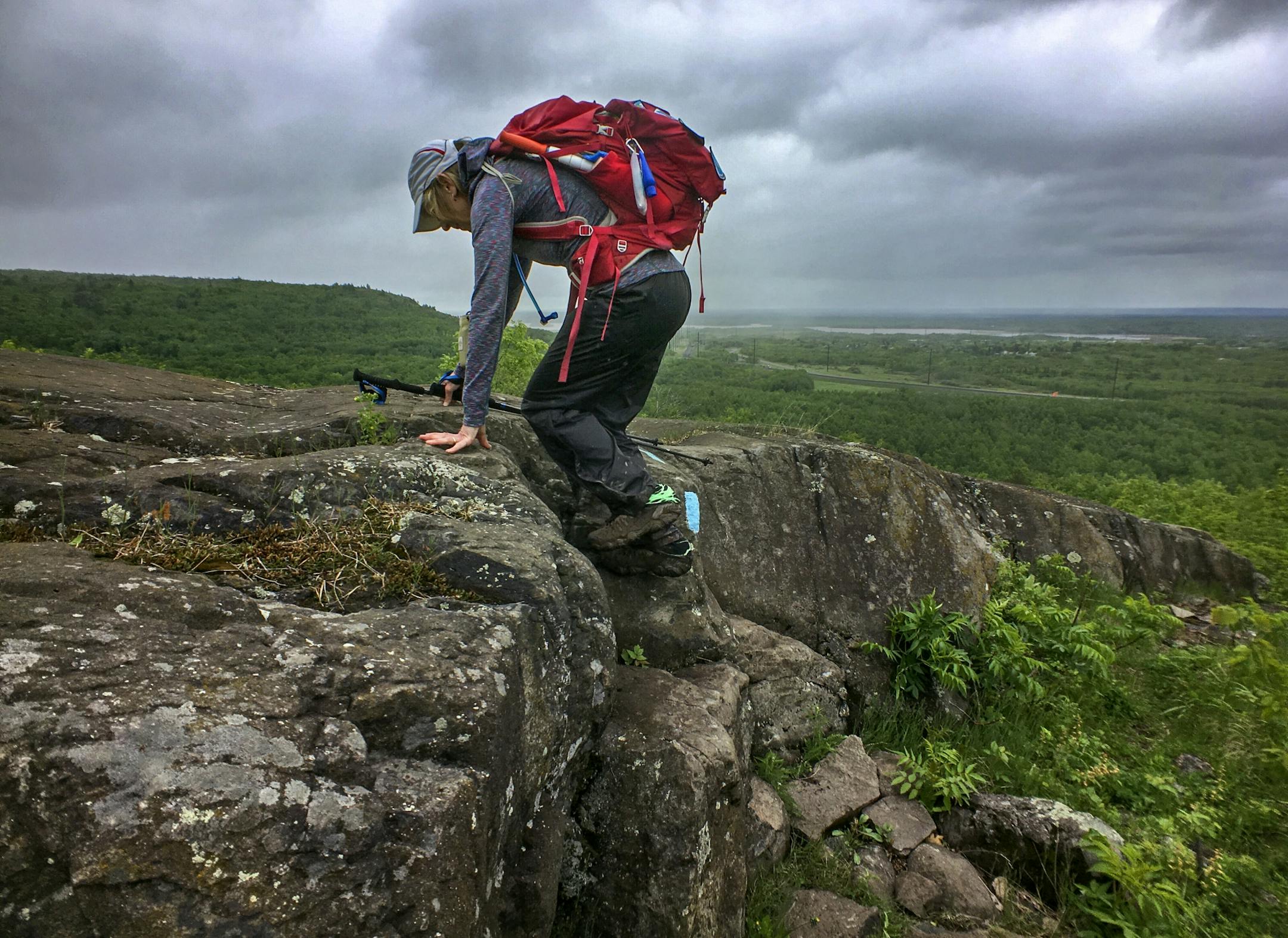Day-2, Day 2 was a killer, with multiple rock and mud covered peaks and valleys through West Duluth. Here, Melanie McManus scales to the top of Ely's Peak.