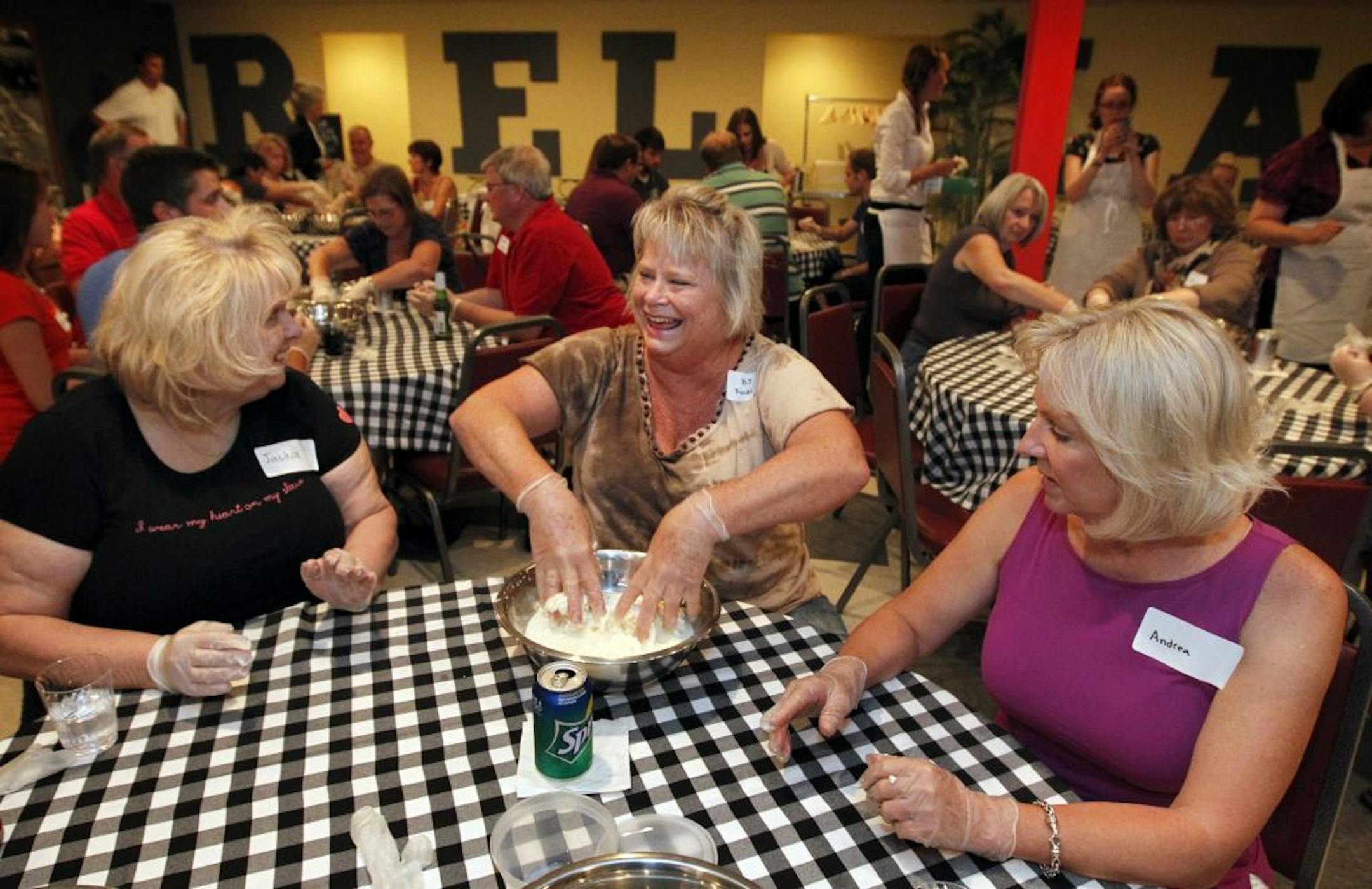 Jackie Severin of Little Canada, B.J. Rode of Golden Valley and Andrea Avery of Eden Prairie made mozzarella cheese together at Mozza Mia in Edina.