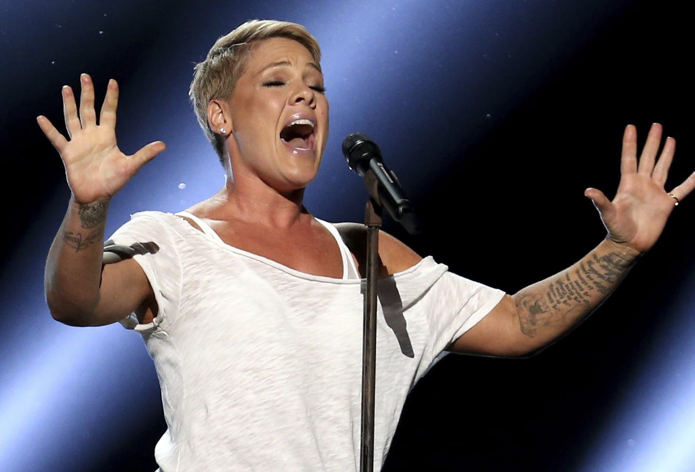 FILE - In this Jan. 28, 2018, file photo, Pink performs "Wild Hearts Can't Be Broken" at the 60th annual Grammy Awards at Madison Square Garden in New York. Pink says she had COVID-19 and is donating $500,000 each to two emergency funds. In a pair of tweets posted Friday, April 3, 2020, the singer says she tested positive after she and her three-year-old son started displaying symptoms two weeks ago. (Photo by Matt Sayles/Invision/AP, File)