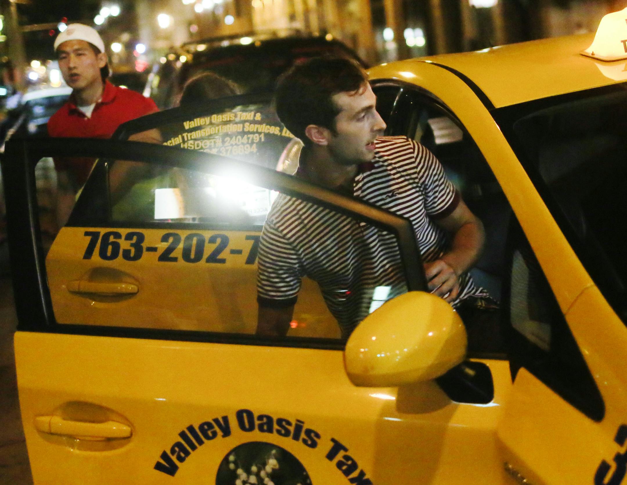 A man gets into a taxi near Target Center June 28, 2014, in downtown Minneapolis.