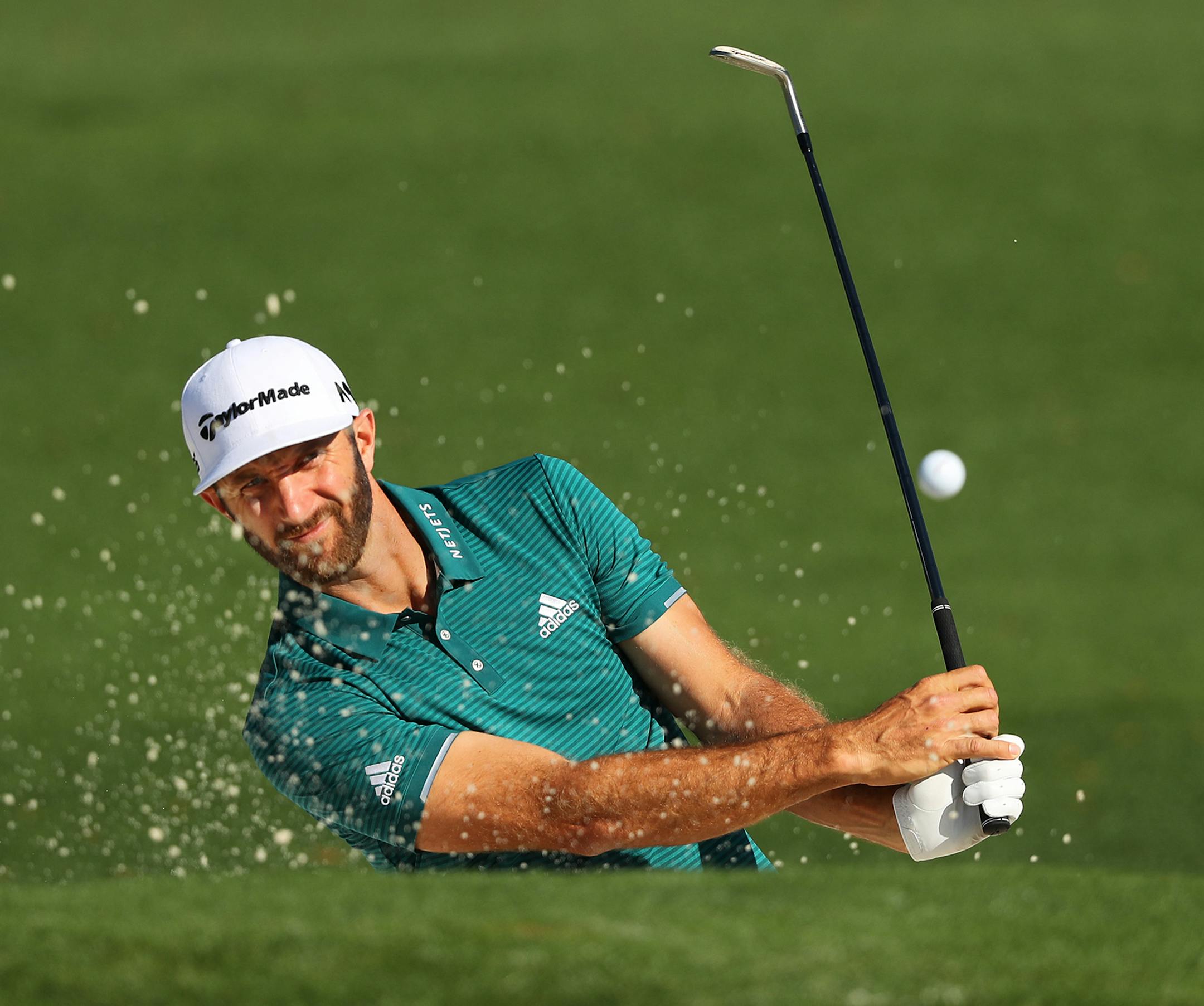 Dustin Johnson hits his sand shot from the bunker to the second green during his practice round for the Masters at Augusta National Golf Club Tuesday, April 4, 2017 in Augusta, Ga. (Curtis Compton/Atlanta Journal-Constitution/TNS) ORG XMIT: 1199908