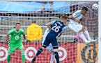 Minnesota United defender Francisco Calvo (5) headed away the ball while guarding Vancouver Whitecaps defender Tim Parker (26) in the second half Satu